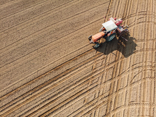 Tractor plowing the fields, aerial view, plowing, sowing, harvest. Agriculture and Farming, campaign. Desert and dehydrated lands, global warming