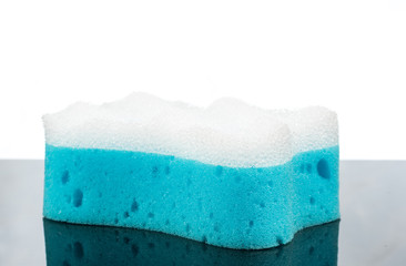 Soap and blue washcloth on a white background