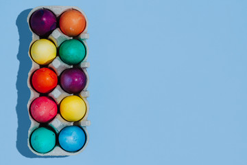 Easter background with Easter eggs. Top view with copy space. multicolored Easter eggs on a blue background