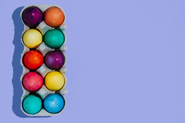 Easter background with Easter eggs. Top view with copy space. multicolored Easter eggs on a blue background