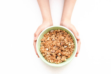 crispy muesli dry Breakfast in a bowl in hands isolated on white background selective focus, top view