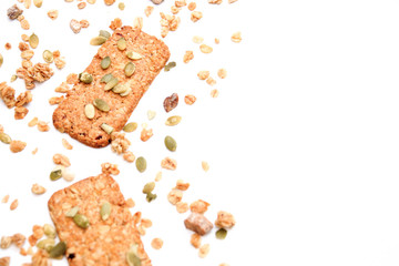 muesli cookies sprinkled with pumpkin seeds, isolated on a white background, selective focus. Top view, copy space