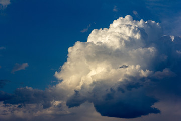 a huge Cumulus cloud in the blue sky