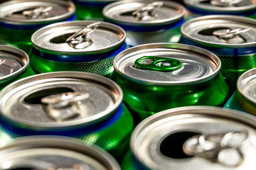  aluminum cans of beer stand in rows on a light background