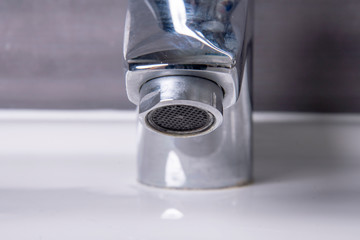 Faucet with lime screen and grey tiles