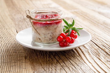 hot smoked mackerel rillettes with confiture of red currants, rosemary, and white wine in a glass jar on wooden background