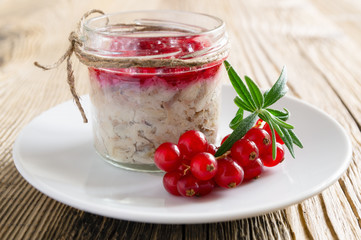 hot smoked mackerel rillettes with red currants and white wine confiture in a glass jar on wooden background