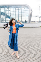 Obraz premium Young pretty girl looks away with a binocular in her hands. The young man travels