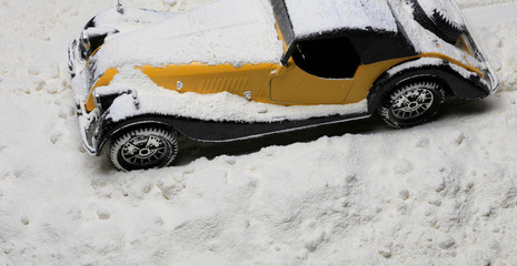 old toy car under snow