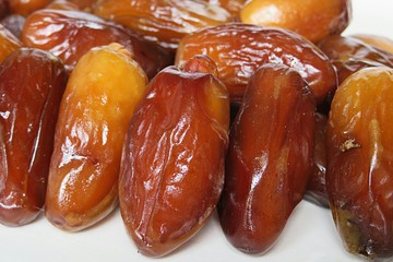 Sweet dried date fruits on white background, closeup