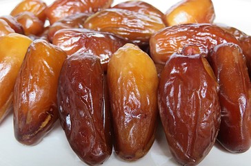 Sweet dried date fruits on white background, closeup