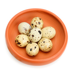 Guail eggs in bowl isolated on white background.