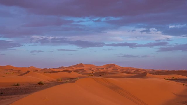 Day to night timelapse of the dunes and the sky in the desert