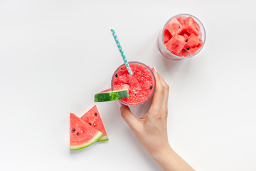 Woman hands with watermelon smoothie glass