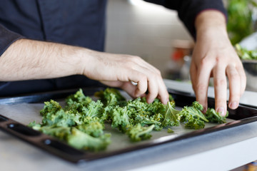 Cook lays out arugula. Baking. Baked. Process. Green. Raw. Homemade. Kitchen. Hands chef. 