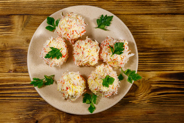 Appetizer of crab-cheese balls on wooden table. Top view