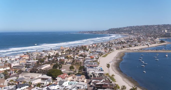 Aerial view flying over San Diego California coastline and beaches on sunny day
