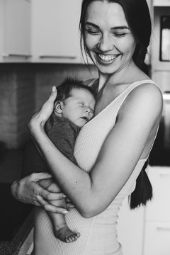 Home portrait of happy mother and newborn baby	