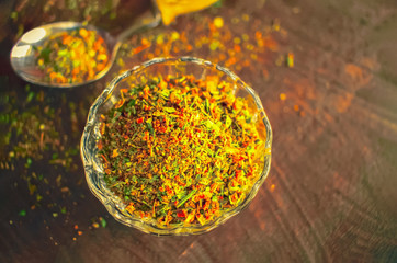 spice mix in glass cup and spoon top view. background with spices.