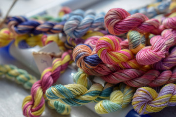 Multicolored threads of floss braided threads for embroidery.