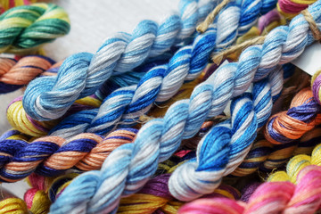 Multicolored threads of floss braided threads for embroidery.