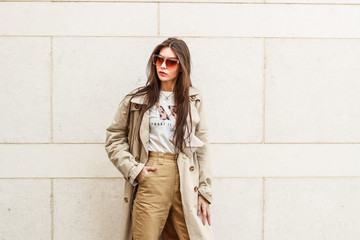 Portrait shooting of a stylish girl. Beige shades. Trends of spring and summer 2019. Pants of...