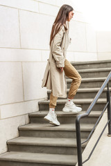 Portrait shooting of a stylish girl. Beige shades. Trends of spring and summer 2019. Pants of...