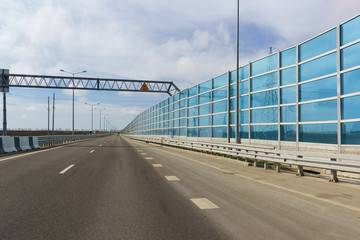 Fototapeta na wymiar Blue light-transmitting noise-absorbing screens on the new road A290 (formerly M25)