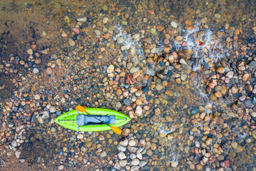 inflatable whitewater kayak on rocks aerial view