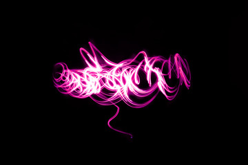 Abstract neon lights trails in the black background. Futuristic overlay light pattern.