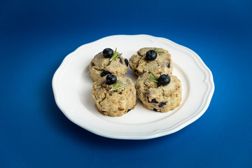 Fresh Baked Raspberry and Blueberry oatmeal wheat Scones set on Blue Background.