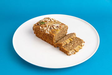 Almond bread loaf with Almond diced and Banana sliced set on Blue Background.