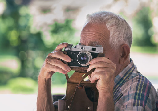 Old man with analog camera