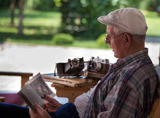 Senior man looking at old photos