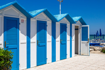 Beautiful old blue and white painted beach huts at Porto Recanati, Province of Macerata, Marche,...