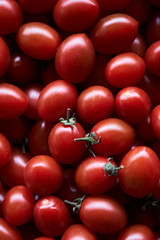 Red cherry tomato food background, close-up, top view. 