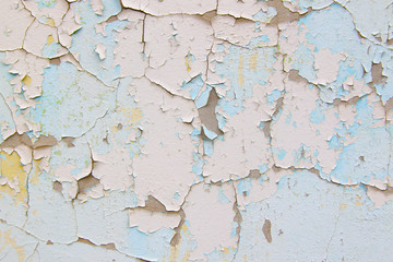 Old cement wall with cracked blue paint texture
