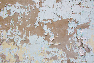Old cement wall with cracked blue paint texture