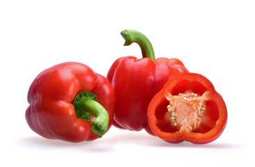 Bright composition of whole and sliced bell peppers with fresh green stems on a neutral white background.