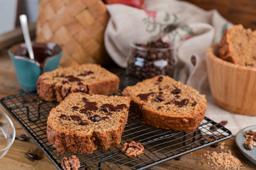 Cake with cocoa and chocolate on a wooden table. Sweet homemade pastries for breakfast. Rustic style photo.