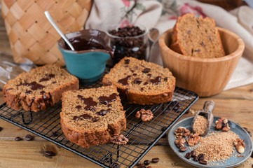 Cake with cocoa and chocolate on a wooden table. Sweet homemade pastries for breakfast. Rustic style photo.
