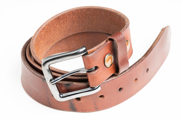 A product fashion shot of a used men's thick leather belt with beautiful patina developed over time...