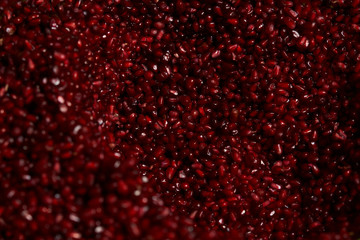 Close up of fresh organic pomegranate seeds background, top view