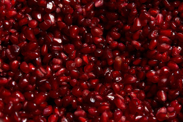 Close up of fresh organic pomegranate seeds background, top view