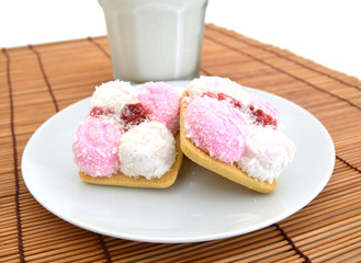 colorful marshmallow cookies in plate and milk  on bamboo mat