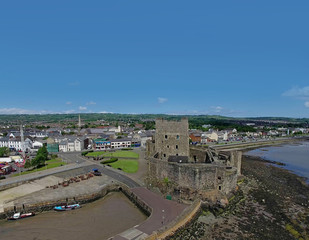 Fototapeta na wymiar Carrickfetgus Castle Co. Antrim Northern Ireland with blue sky background space for editors text copy 1k