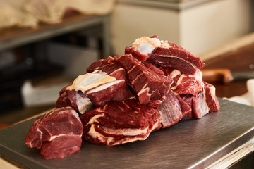 Fototapeta premium Fresh uncooked sliced meat on scales in meat market 