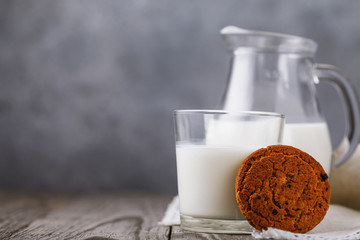 Healthy food for breakfast: milk with oatmeal cookies on a wooden table with copy space