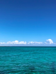Fototapeta na wymiar Turquoise sea background with clouds. 