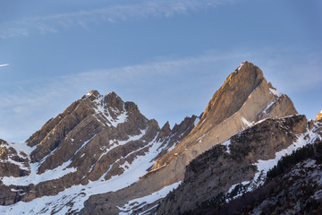 Sharp edge mountain peaks with some snow showing the climbing rock